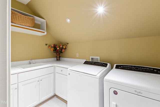 washroom featuring cabinets, separate washer and dryer, and sink