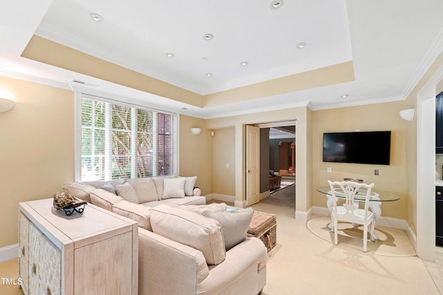 living room with crown molding, light carpet, and a tray ceiling