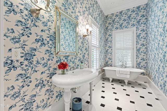 bathroom with tile patterned floors, a bath, a healthy amount of sunlight, and crown molding