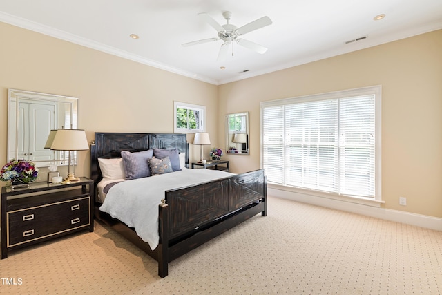 carpeted bedroom with ceiling fan and crown molding