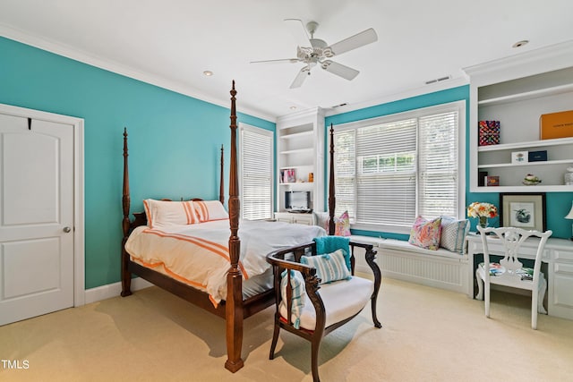 carpeted bedroom with ceiling fan and ornamental molding