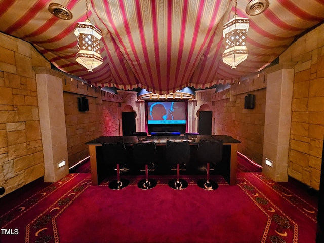 carpeted home theater room featuring lofted ceiling