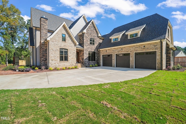 view of front of property with a garage and a front lawn