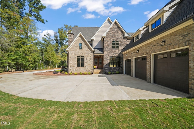 view of front of property featuring a garage and a front lawn