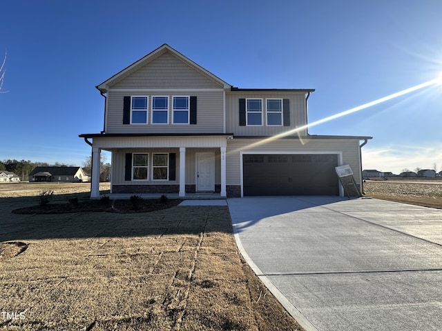 view of front facade with a garage, a front lawn, and covered porch