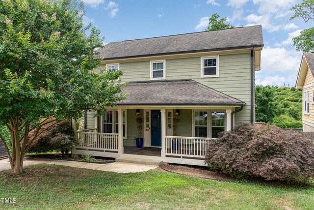 view of front of home featuring covered porch and a front yard