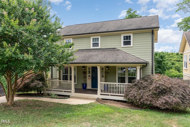 view of front of property featuring covered porch and a front lawn