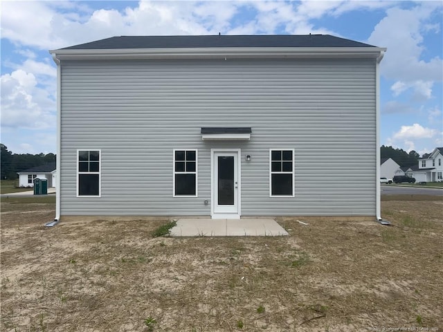 rear view of house featuring central AC unit and a patio