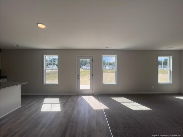 unfurnished living room with dark hardwood / wood-style flooring