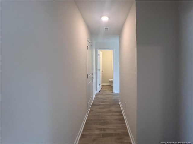 corridor featuring dark hardwood / wood-style flooring