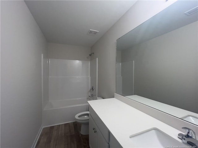 full bathroom featuring shower / tub combination, vanity, toilet, and wood-type flooring