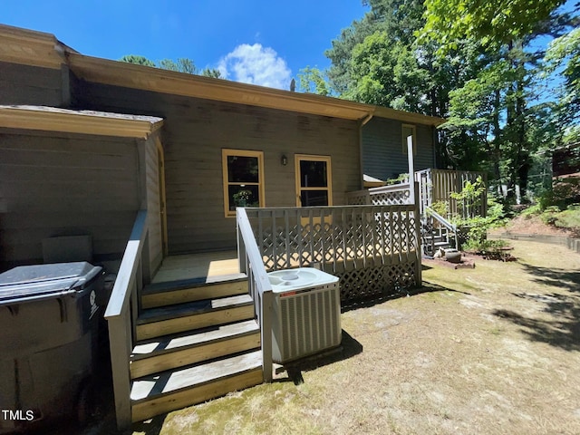 property entrance with a wooden deck and central AC