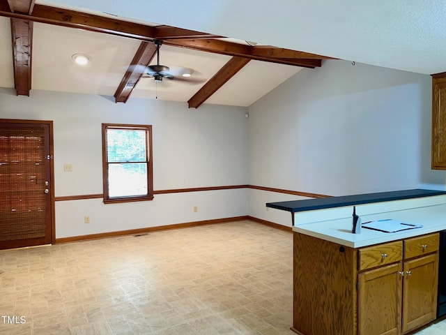 kitchen with lofted ceiling with beams and ceiling fan