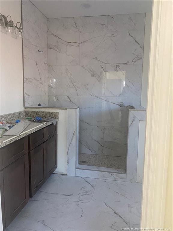 bathroom with a shower and vanity