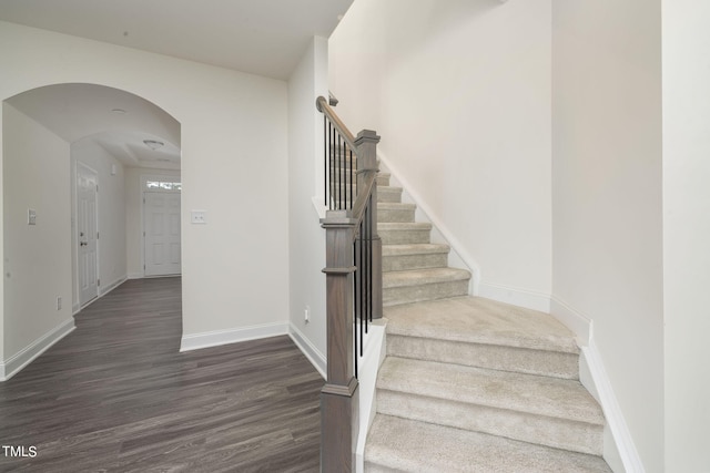 stairs with dark wood-type flooring