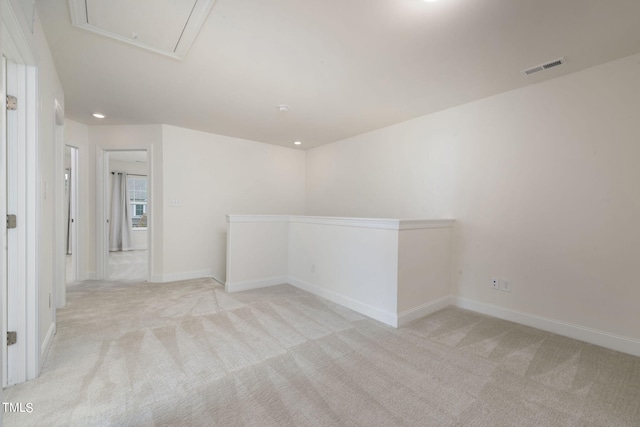 unfurnished room featuring light colored carpet