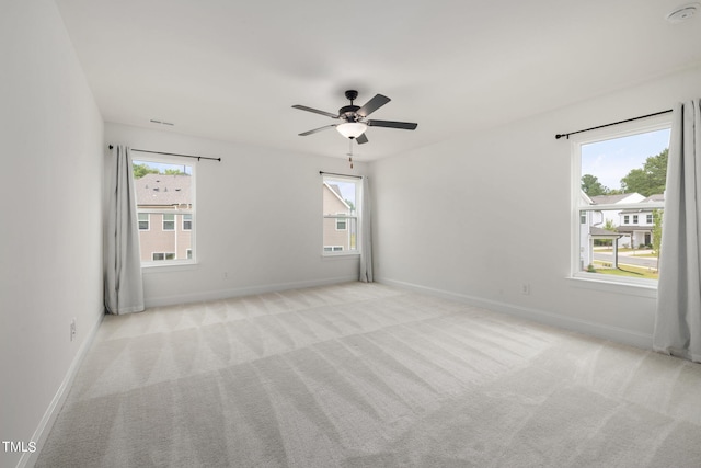 spare room with light carpet and ceiling fan