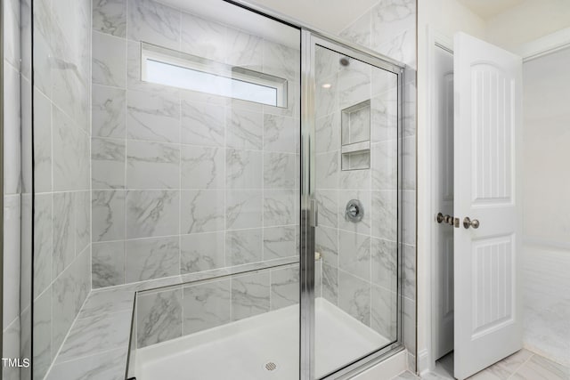 bathroom with tile patterned flooring and an enclosed shower