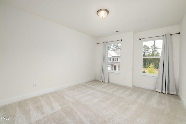 unfurnished room with light colored carpet