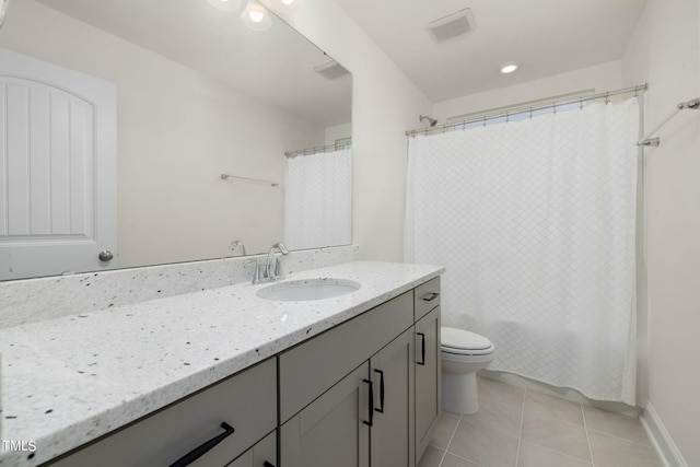 bathroom featuring vanity, tile patterned flooring, and toilet