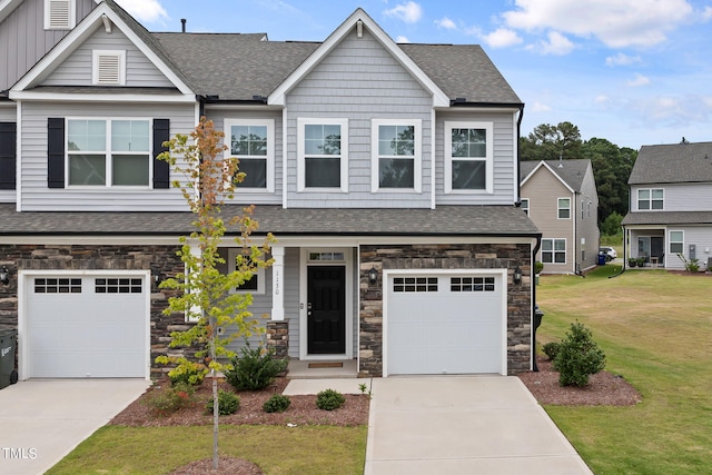 craftsman-style home featuring a garage and a front lawn