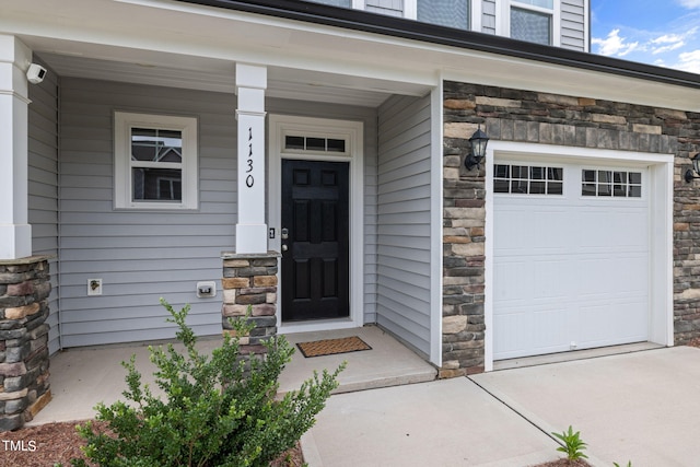 property entrance with a garage and covered porch