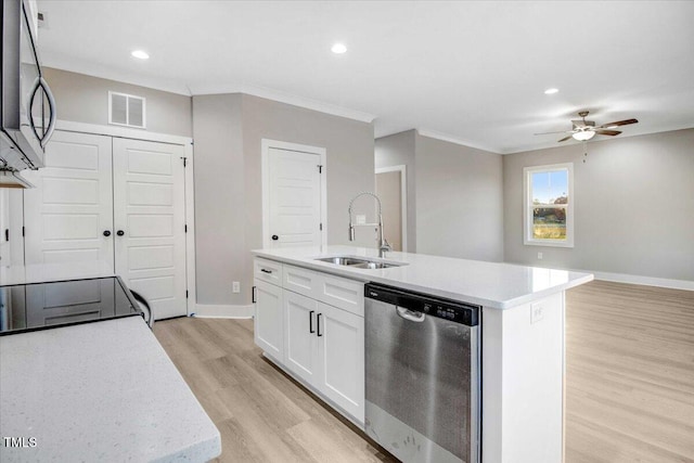 kitchen featuring sink, an island with sink, light hardwood / wood-style floors, white cabinetry, and stainless steel appliances