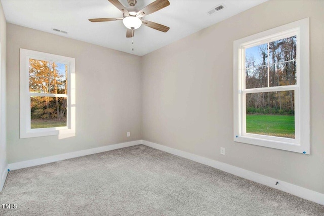 empty room with ceiling fan and carpet floors