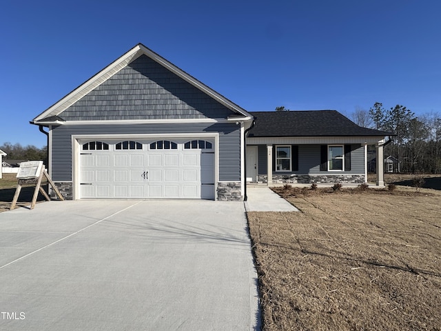 view of front of house with covered porch and a garage