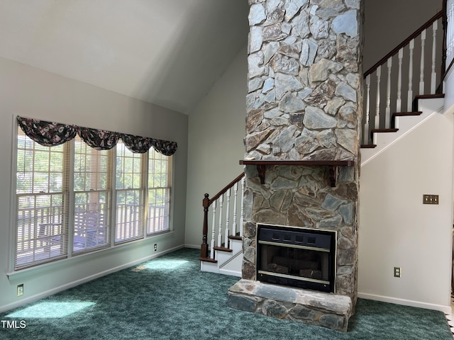 unfurnished living room with dark carpet, a stone fireplace, and high vaulted ceiling