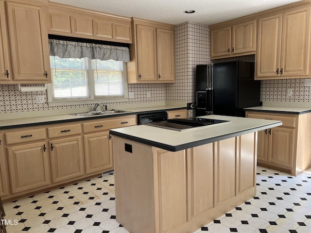 kitchen featuring tasteful backsplash, sink, a center island, black appliances, and a textured ceiling