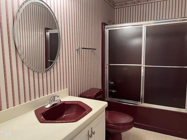 full bathroom with toilet, vanity, and shower / bath combination with glass door