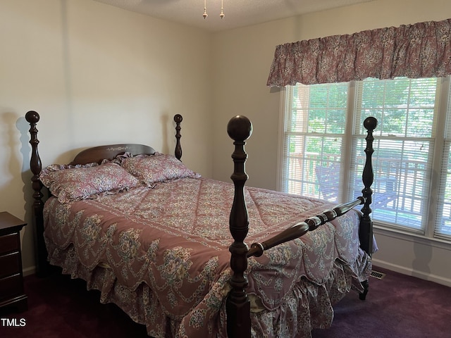 bedroom featuring dark colored carpet