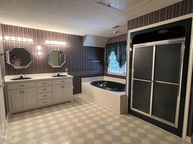 bathroom featuring vanity, shower with separate bathtub, and a textured ceiling