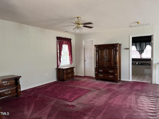 unfurnished bedroom featuring ceiling fan, carpet floors, and a textured ceiling