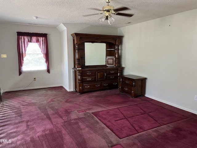 unfurnished bedroom with ceiling fan, a textured ceiling, and carpet flooring