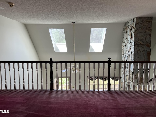 room details featuring a skylight, carpet floors, and a textured ceiling