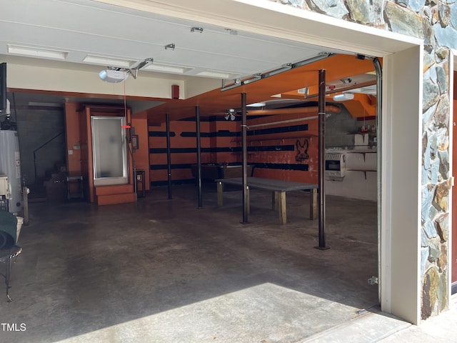 garage featuring a garage door opener and water heater