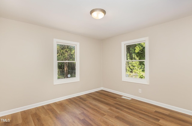 spare room featuring hardwood / wood-style flooring