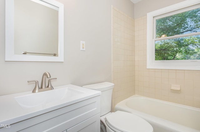 full bathroom featuring vanity, toilet, and tiled shower / bath combo