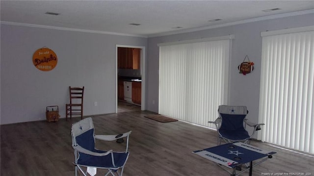 living area featuring dark hardwood / wood-style flooring and ornamental molding