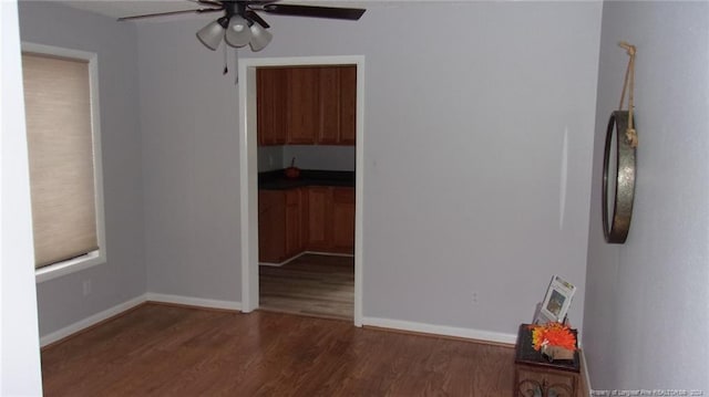 spare room with ceiling fan and dark hardwood / wood-style flooring