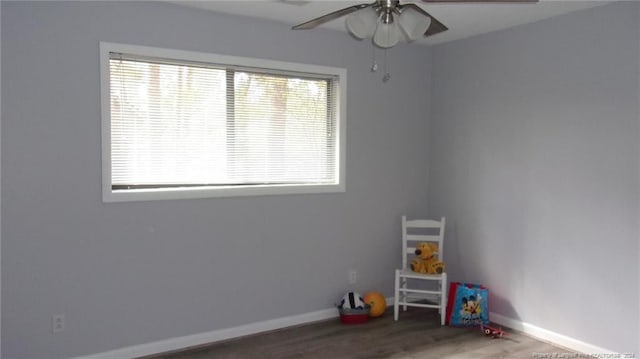 playroom featuring dark hardwood / wood-style flooring and ceiling fan