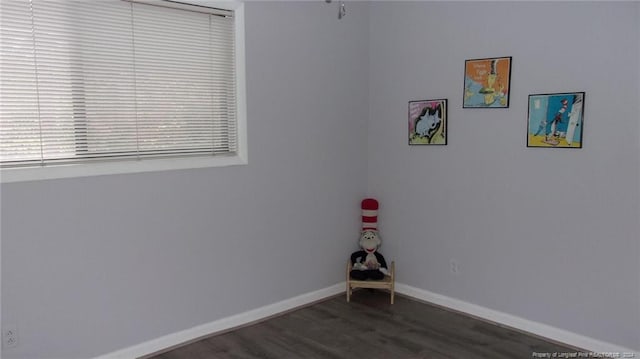 unfurnished room with dark hardwood / wood-style flooring