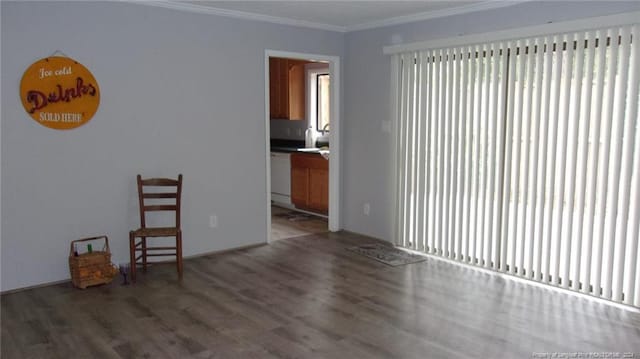 unfurnished room with dark hardwood / wood-style floors and crown molding