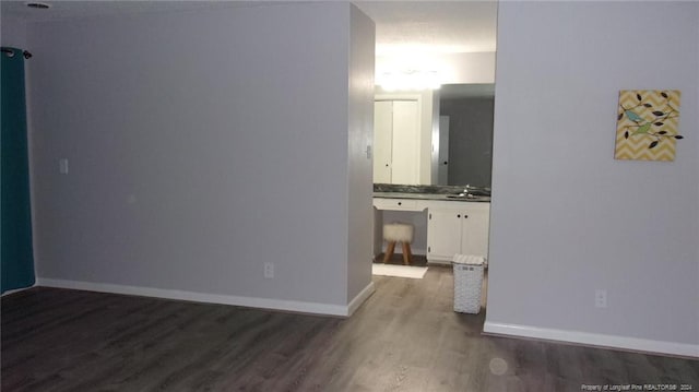 hallway featuring dark hardwood / wood-style flooring and sink