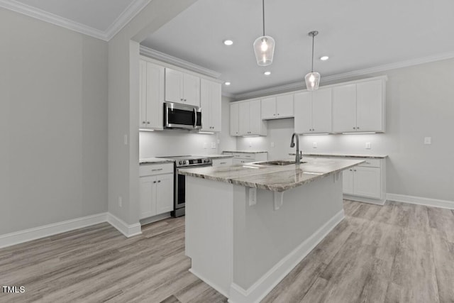 kitchen featuring a center island with sink, sink, white cabinetry, and stainless steel appliances