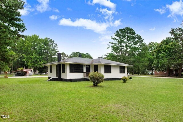 325 Bell St, Enfield, NC 27823 - view of front facade with a front lawn and a chimney