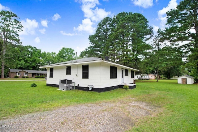 325 Bell St, Enfield, NC 27823 - view of side of property with a storage shed, a yard, crawl space, and view of wooded area