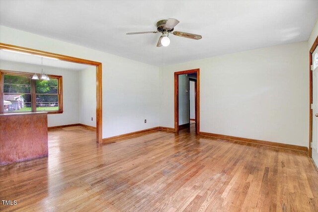 325 Bell St, Enfield, NC 27823 - spare room with wood finished floors, ceiling fan, and a chandelier
